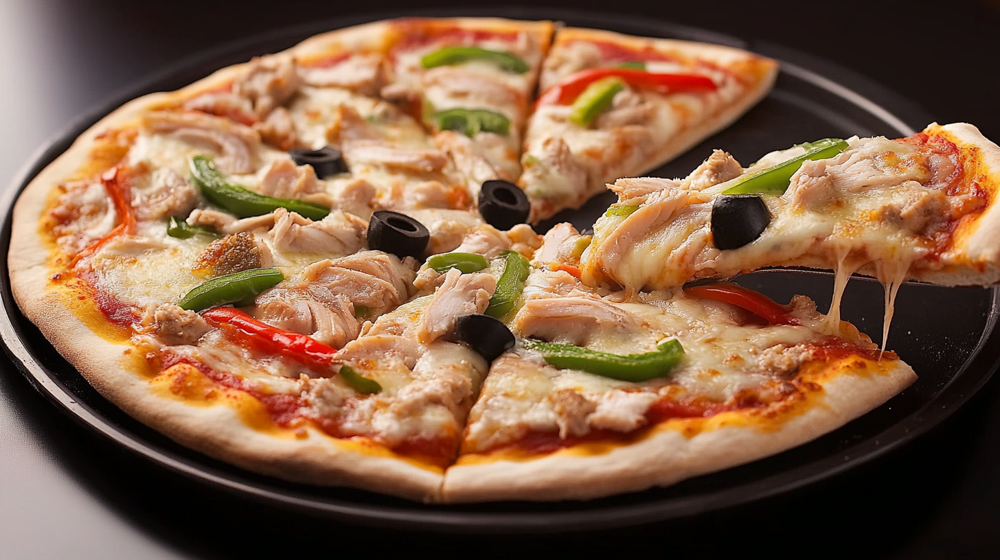 Delicious tuna fish pizza with melted cheese, black olives, and colorful bell peppers on a crispy crust.
