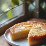 Close-up of a moist banana cake kukus with a golden crust and soft texture.