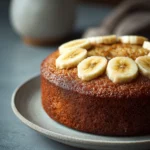 Close-up of a banana cake slice on a plate with a clean background
