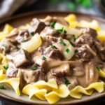 Close-up of beef stroganoff crockpot freezer meal with creamy sauce and herbs