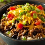 Close-up of high protein beef enchilada bowls with vibrant toppings and warm lighting.