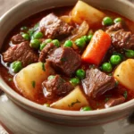 Close-up of a hearty beef stew in an instant pot with visible chunks of beef and vegetables.