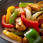 Close-up of a vibrant Mexican chicken stir-fry with colorful vegetables