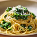 Close-up of one pot pasta with zitrone and spinach in a creamy sauce