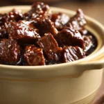 Close-up of slow cooker beef teriyaki with glossy sauce and sesame seeds