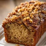 Close-up of banana bread with brown sugar streusel topping on a clean white background.