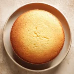 Close-up of a vanilla cake without eggs, showcasing a smooth, creamy texture.