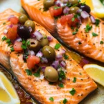 Close-up of air fryer salmon with Mediterranean herbs and lemon slices