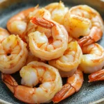 Close-up of air fryer shrimp on a white plate with a clean background