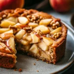 Close-up of a sugar-free apple cake with a golden crust and visible apple slices.