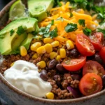 Close-up of ground beef taco bowls with vibrant toppings and fresh ingredients