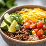 Close-up of a high protein beef taco bowl with vibrant vegetables and toppings.