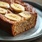 Close-up of Jamie Oliver banana cake with a golden crust on a white plate