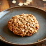 Close-up of oatmeal cookie mix with visible texture and warm lighting, perfect for baking enthusiasts.