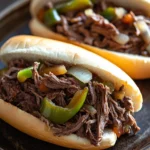 Close-up of slow cooker Melissa Jo Italian beef with rich textures and warm lighting.