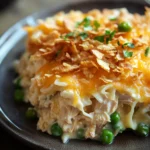 Close-up of a creamy tuna casserole with jalapeno, topped with melted cheese and crispy breadcrumbs.